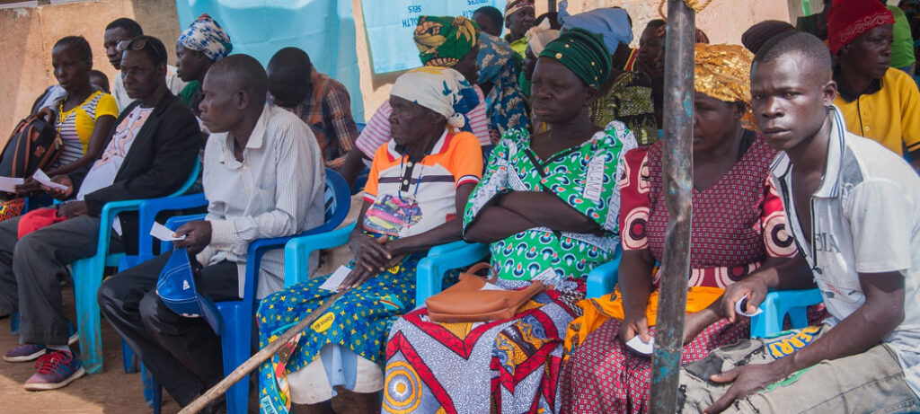 a group of people waiting in line to be seen by a doctor