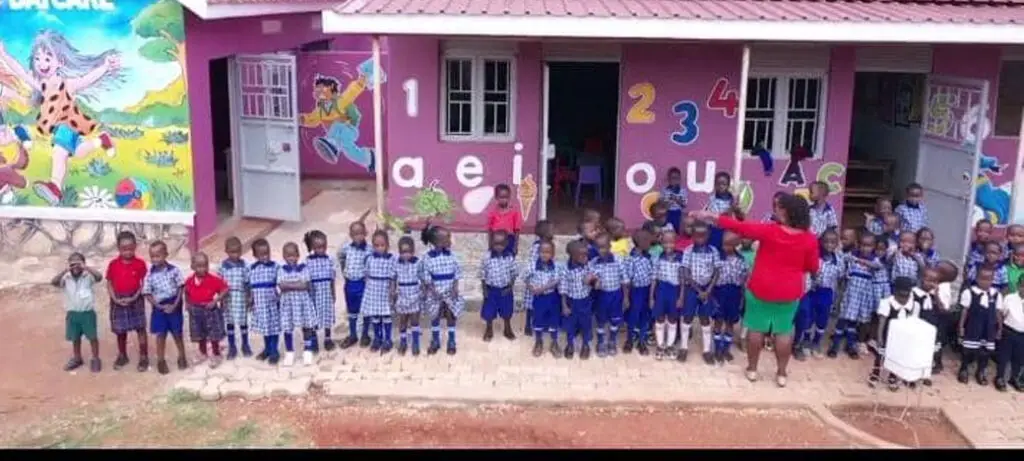 Pre-School kids standing out in front of their school