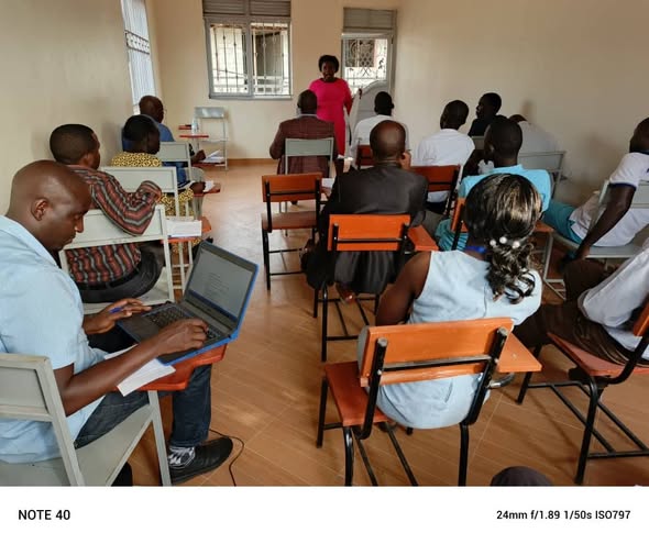 Group of people sitting and listening to a speaker